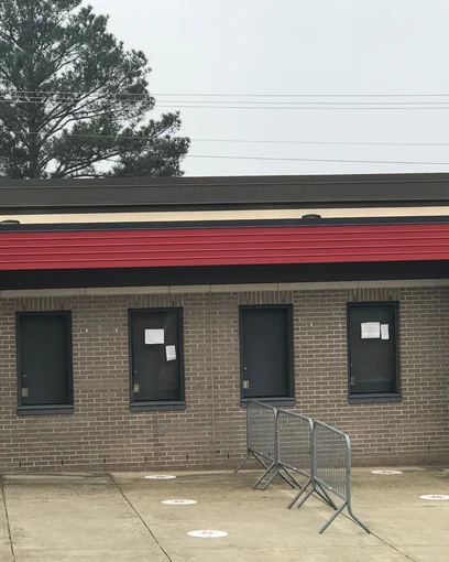 Ticket booth windows set in brick at an Alabama high school stadium in 2021, the mortar one even color