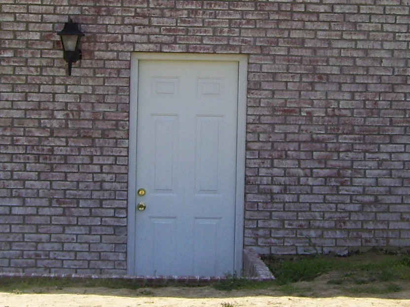 The same side door later in 2008, the header course now sitting in the same range as the brick faces around it