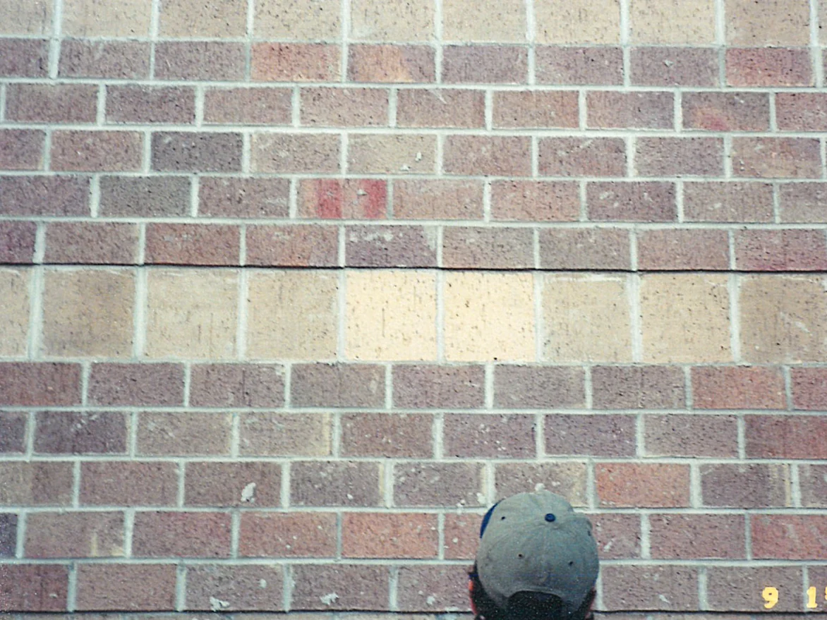 Close view of the same brick in 2000, a course of large square units running across the wall much paler than the brick above and below it
