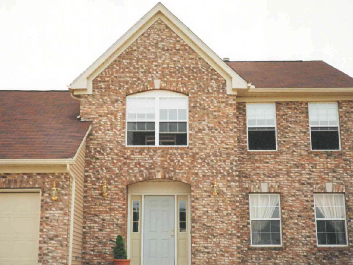 The front of the house in 1997 after the markings were added, the brick reading as one blended range from the gable down past the entry to the garage wing