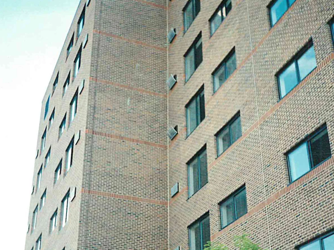 The same building with its windows in, the buff brick showing lighter stripes and blotchy patches where the two runs meet