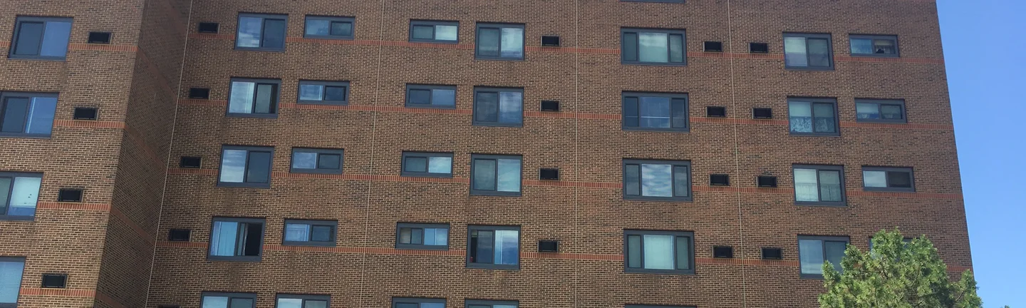 The Canton high rise in 2019, its brick reading as one even red-brown across every storey