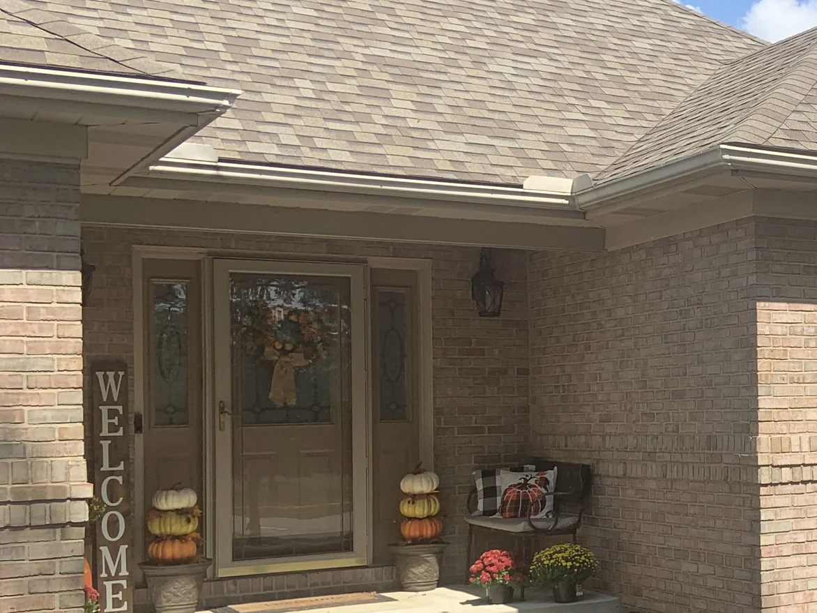 The covered front entry in 2019, the brick at the porch and the return wall reading as one blend of cream, buff and soft pink