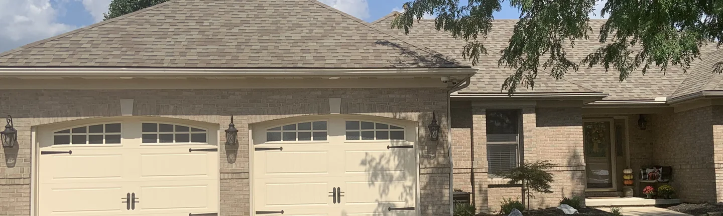 The Carlisle house from the driveway in 2019, its brick one even cream and tan range across the garage bays