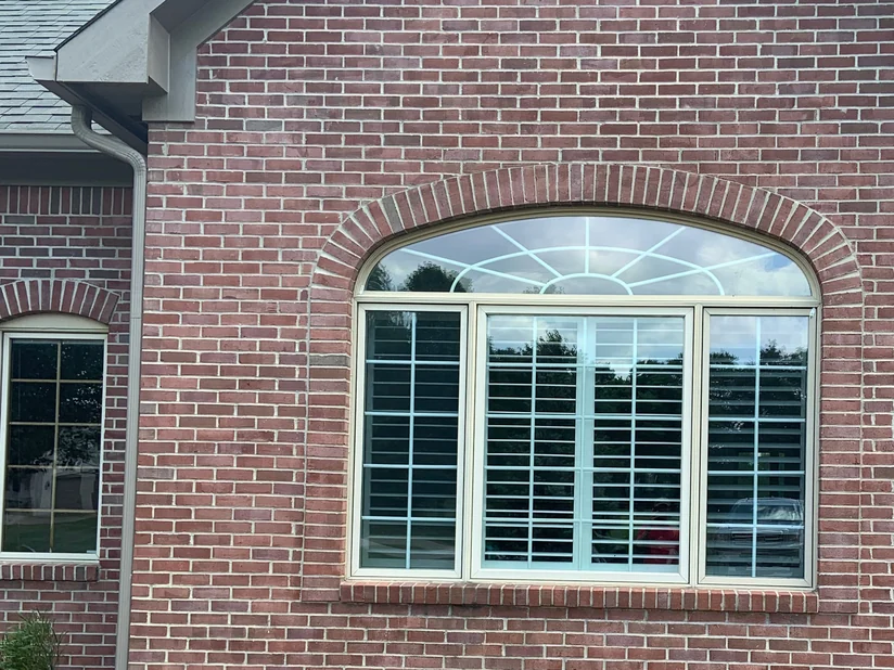 The same gable in 2019, the brick one even tone around the arched window