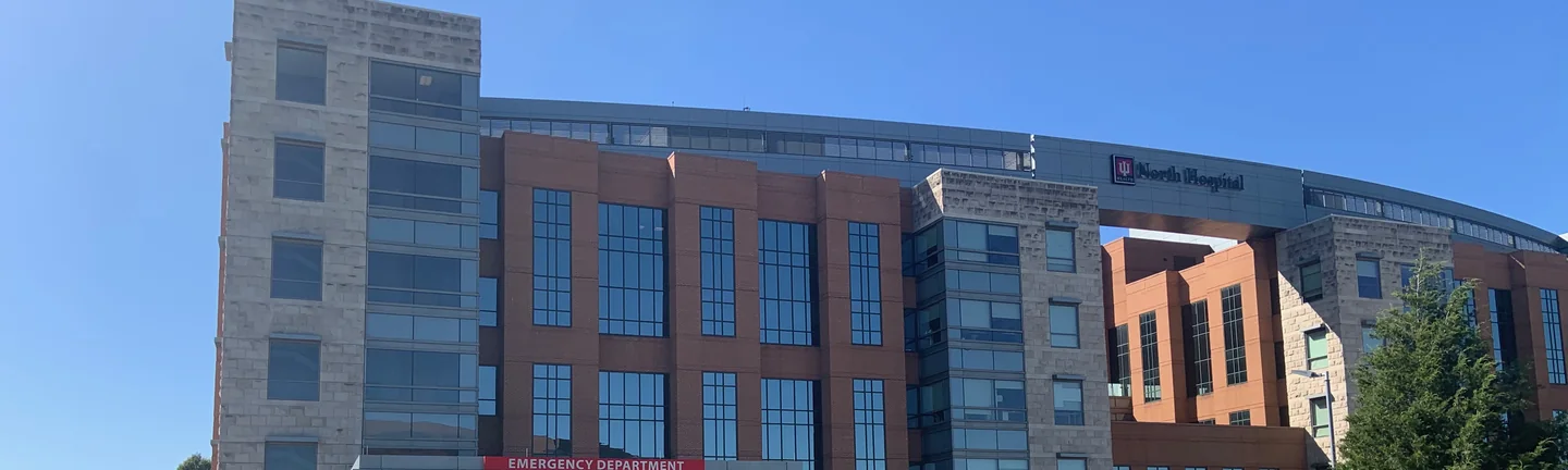 The Carmel medical center from its approach road in 2019, brick bays and a limestone tower above the emergency department canopy