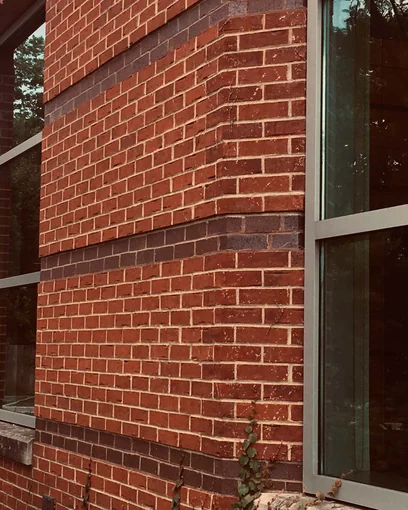 The corner of a Chicago bank in 2019, the angled corner brick matching the wall fifteen years after staining