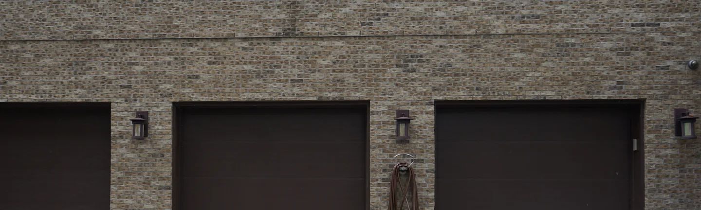 The garage addition in 2019, its brick reading as one warm tan and brown blend across three bays