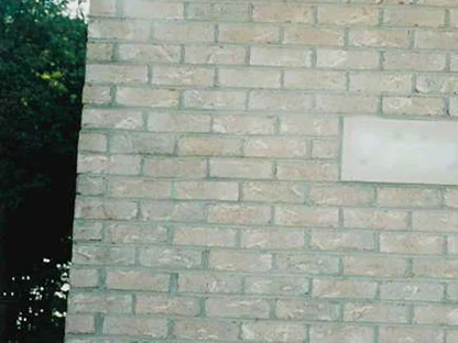 The same close-up of the buff brick in 1998 after the work, the corrected unit no longer visible in the wall beside the hose bib