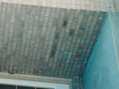 The recessed entry corner in October 1998 before the work, a band of dark stripped brick running across the wall beside the door