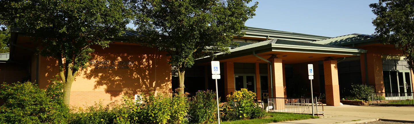 The Richard A. Young Recreation Center from its parking lot in 2019, the brick reading as one warm red and tan range