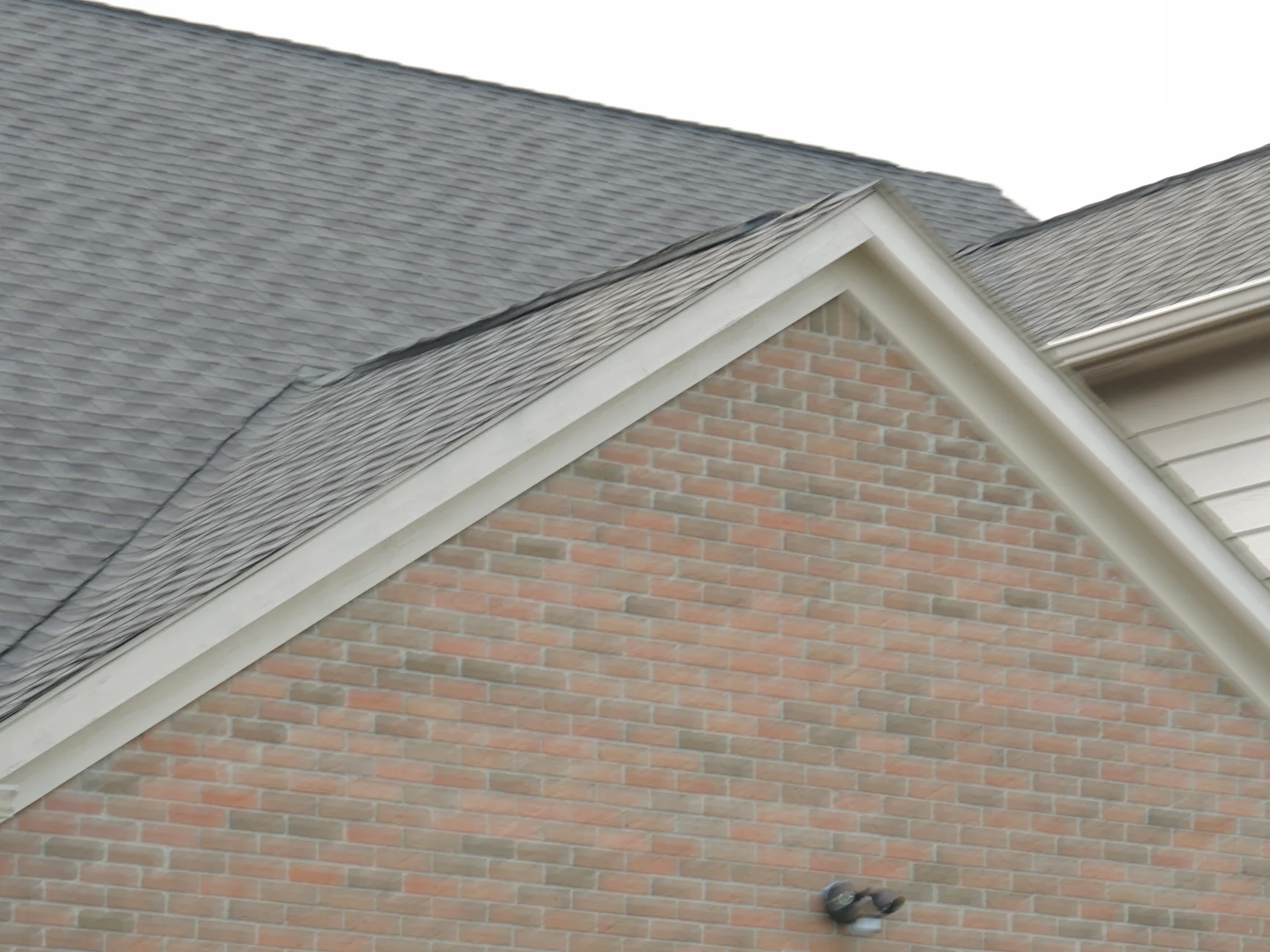 The same gable fifteen years on, the whole field reading as one range of red and tan brick from the eaves to the apex