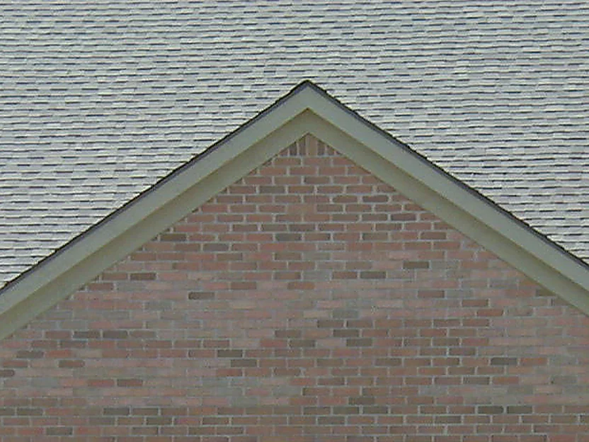 The garage gable in 2004, a scatter of brick through the range reading paler and pinker than the units around them