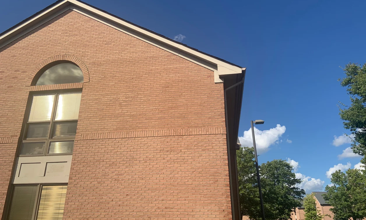 The gable end of a two-story office center in Dublin, Ohio in 2019, fourteen years after its dark brick was lightened