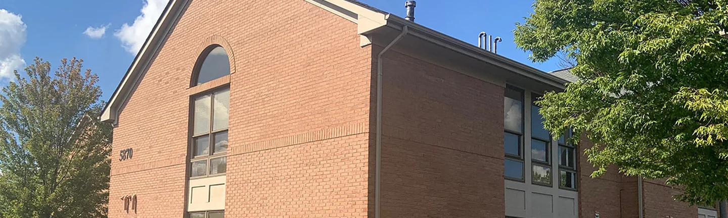 The brick gable end and long elevation of a two-story Dublin office in 2019, reading as one red range
