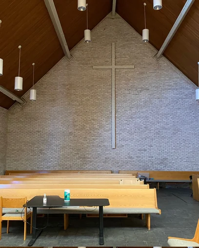 The inside wall of a church in Elmhurst, Illinois in 2021, the pale brick one even range thirty-two years after staining