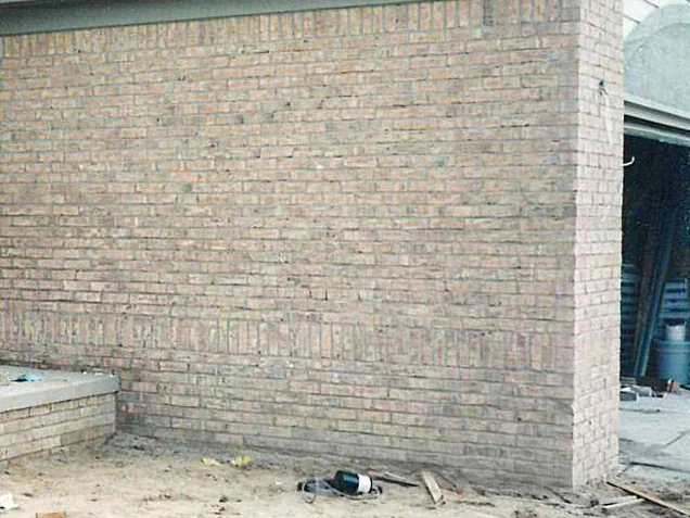 The same gable end wall in 1998 after the work, the bottom courses reading with the rest of the wall under the gray green fascia