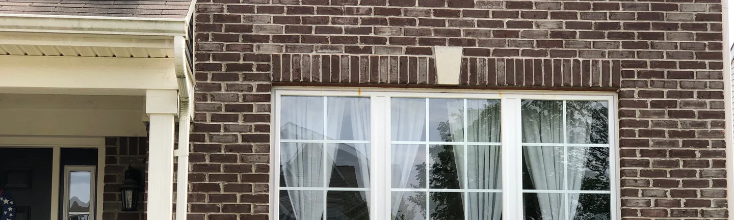 The front of the Fishers house in 2019, its brick an even dark red and brown range beside the entrance
