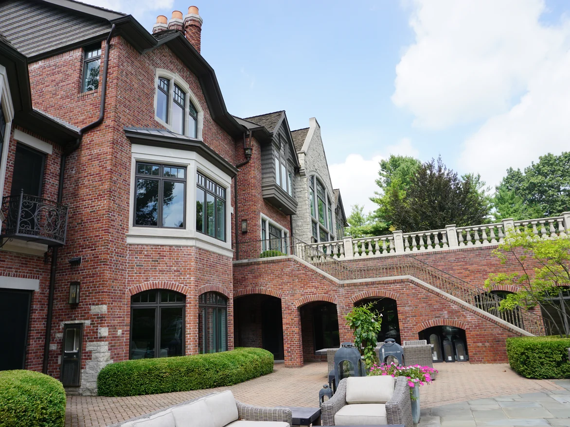 The brick terrace and the arched openings beneath the stone balustrade in 2019, the color varying from unit to unit with no patches