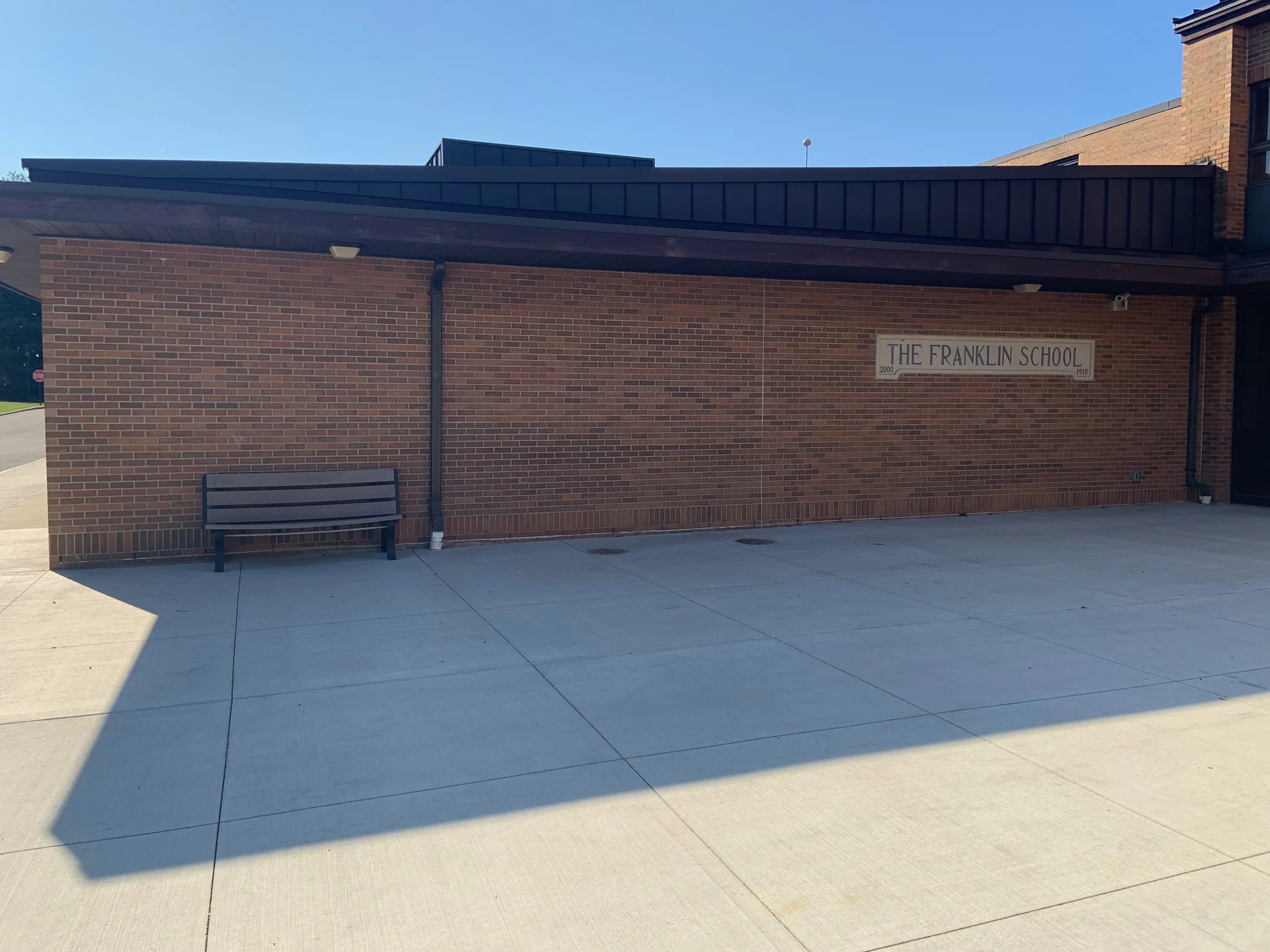 The low entrance range in 2019 seen along its length above a bench, the brick one consistent red brown range from end to end