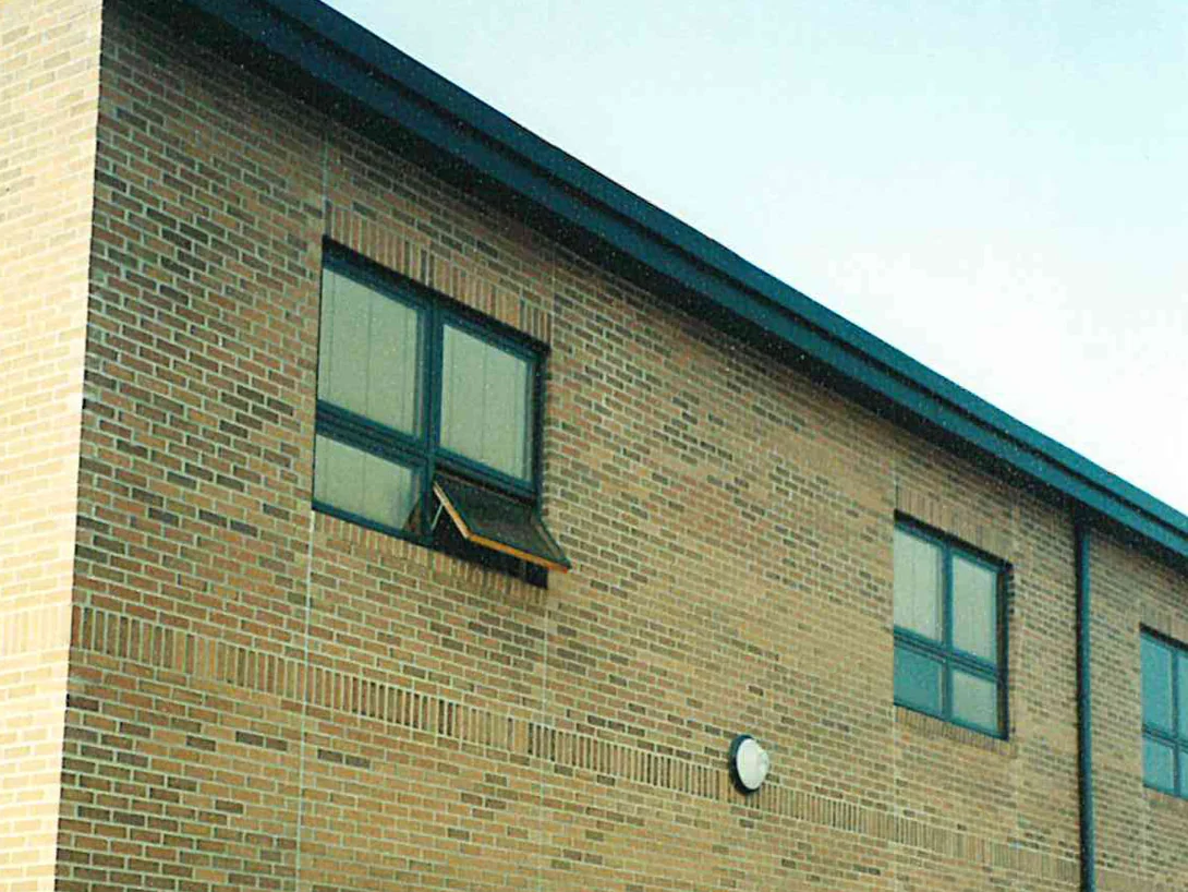 The upper wall of the school in 2000, the pale buff brick at the corner running noticeably lighter than the banded field beside it