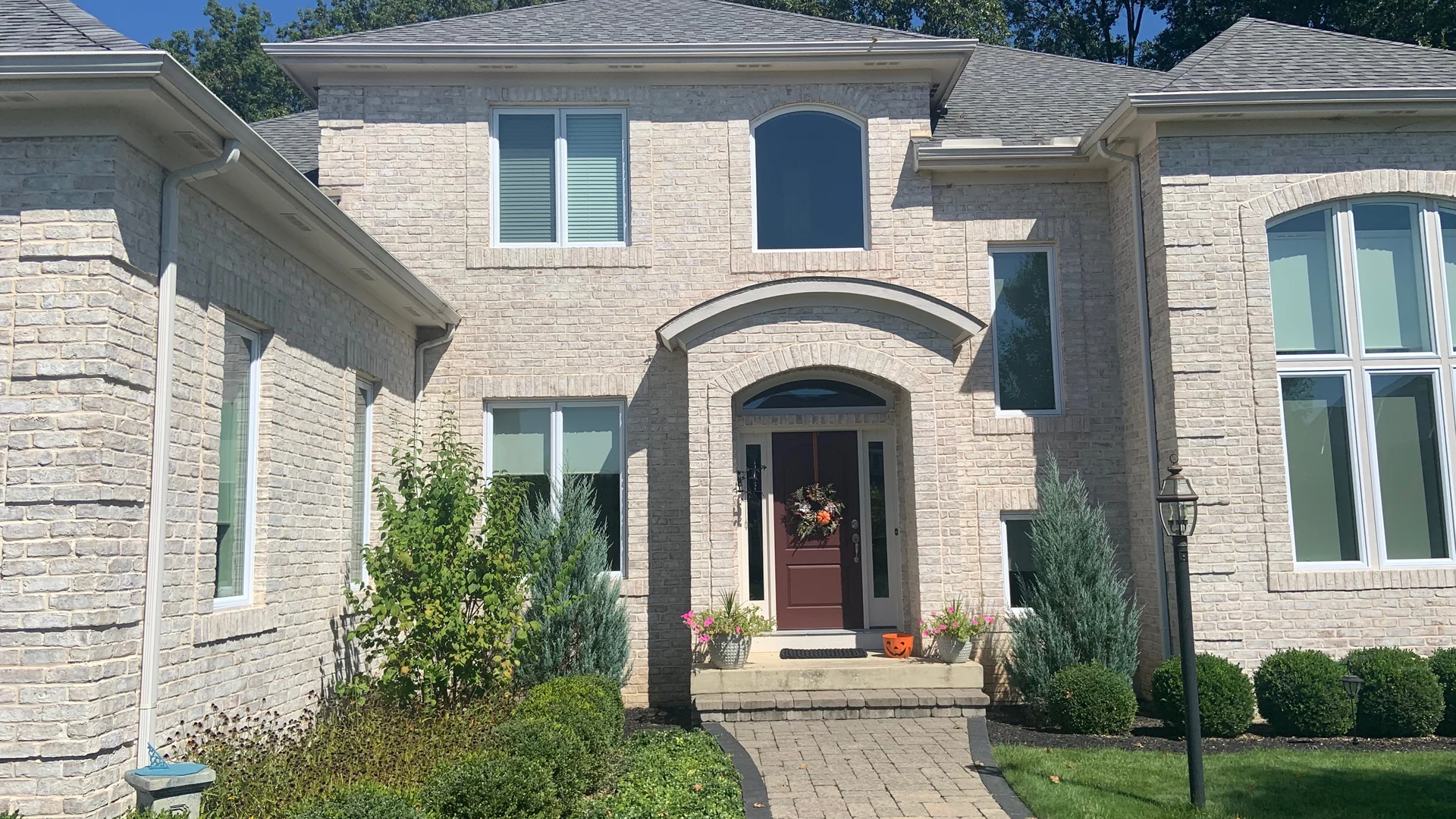 A two-story white brick home in Galena, Ohio in 2019, eight years after its faded brick was stained back to white