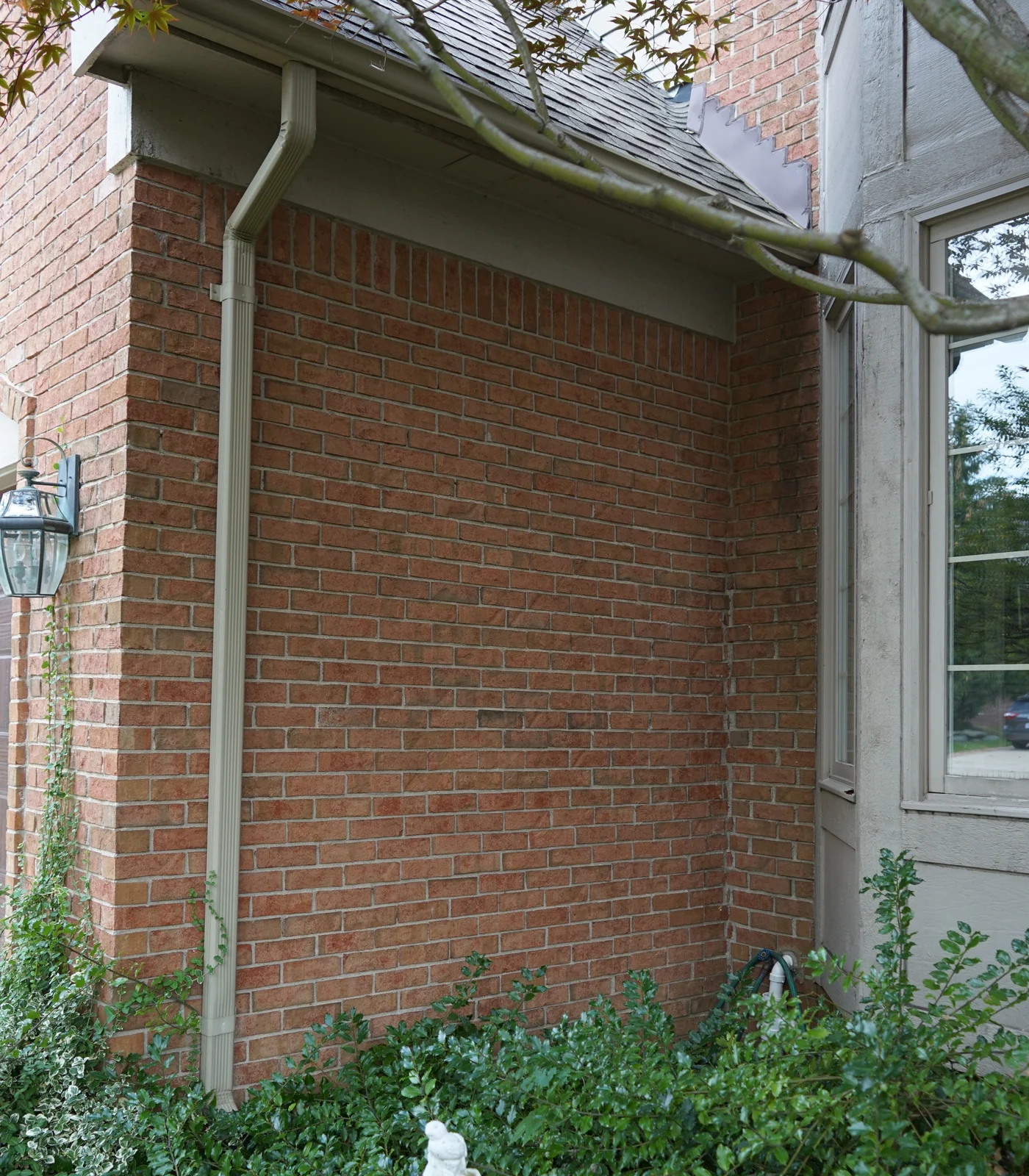 A brick wall beside a bay window on a Glenmoore, Michigan home in 2019, twenty years after dark units were lightened