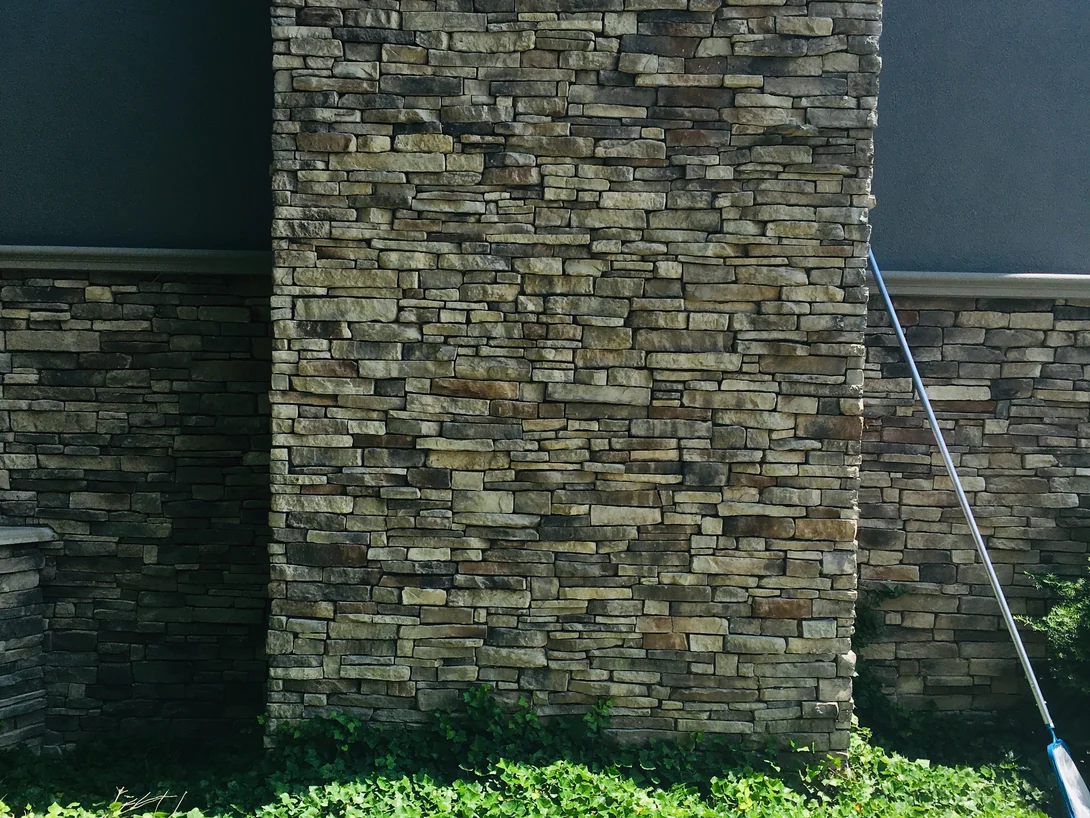The foot of the chimney in 2019 where it meets the garden walls, the corner reading as one range with the flat wall on either side of it