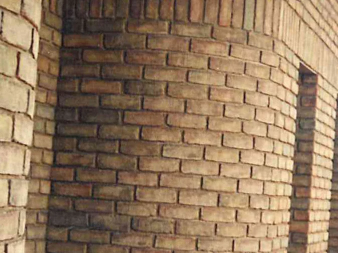 Close on a curved corner in 1994 after the work, the radial shapes and the flat brick either side of them reading as one tan range