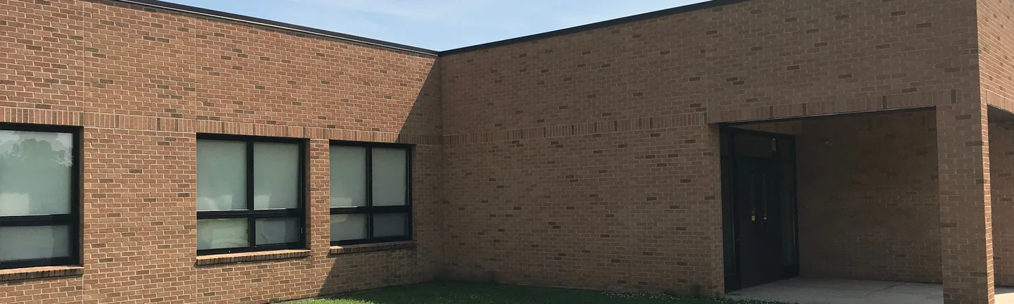 Two wings of Greene Elementary in 2019, the brick reading as one blend across both walls