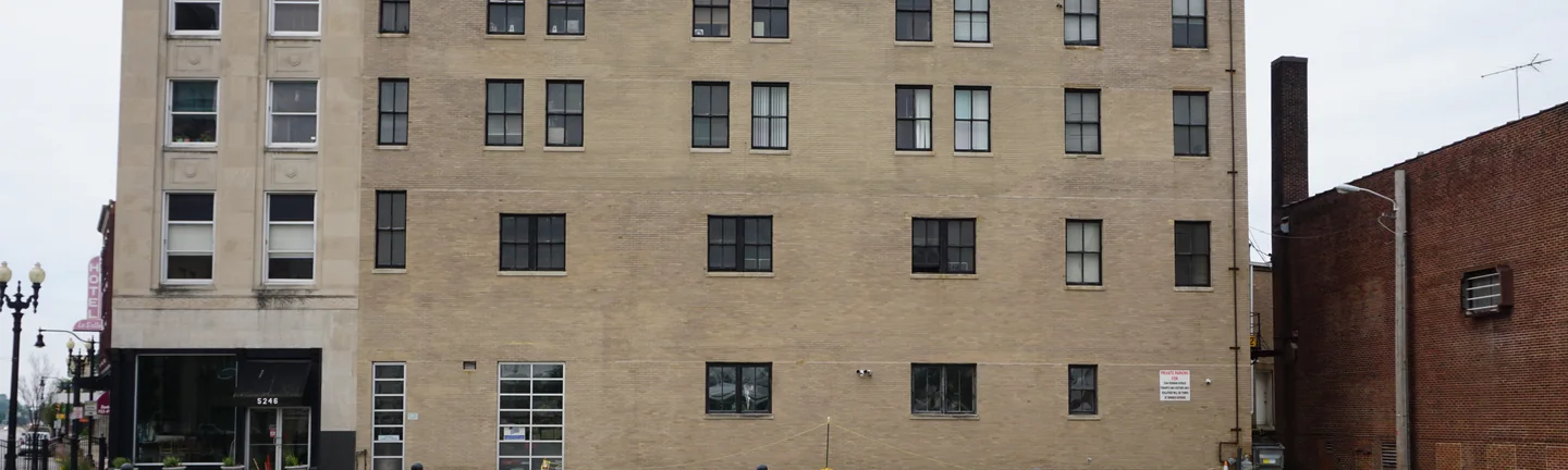 The main wall of the Old Hammond Building in 2019, its buff brick reading as one range across the whole elevation