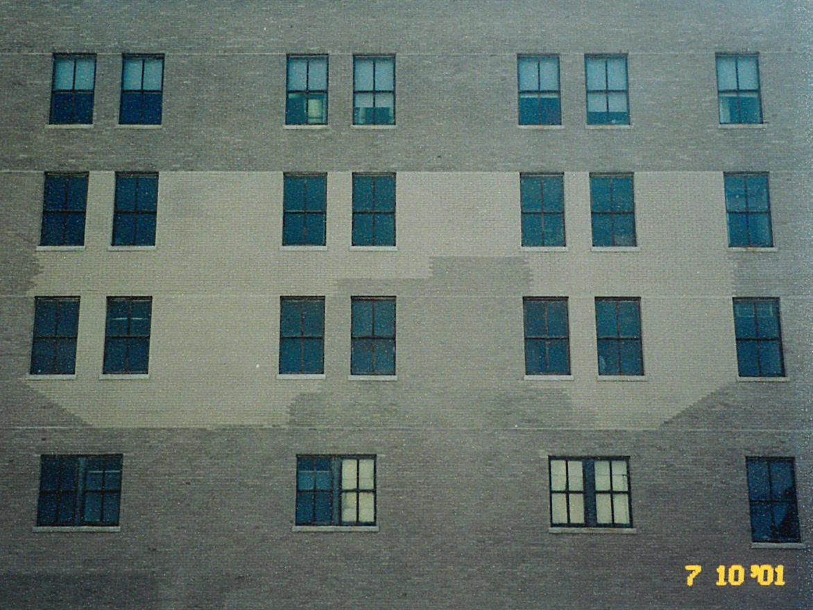 The main wall in 2001, a wide pale block of brick running across two stories between the window bays against the darker brick around it