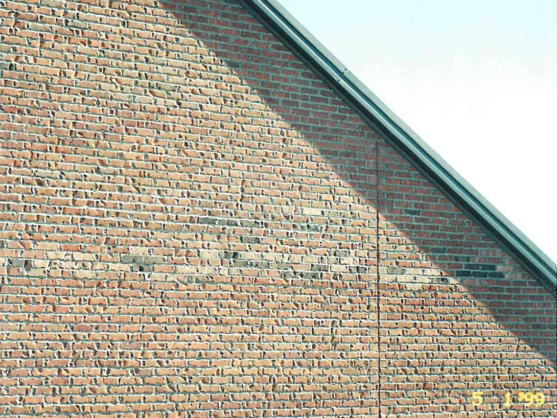 The gable end below its sloping roof line in 1999, the wall pale buff in the sun and a deeper red brown in the shade, with a film date stamp burned into the corner