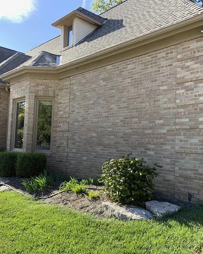 The corner of a Hilliard, Ohio home in 2019, the addition and the original brick reading as one wall