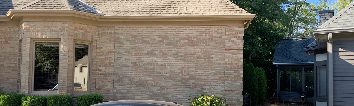 The Hilliard house from the street in 2019, the brick on the addition and the original walls reading as one buff and rose range