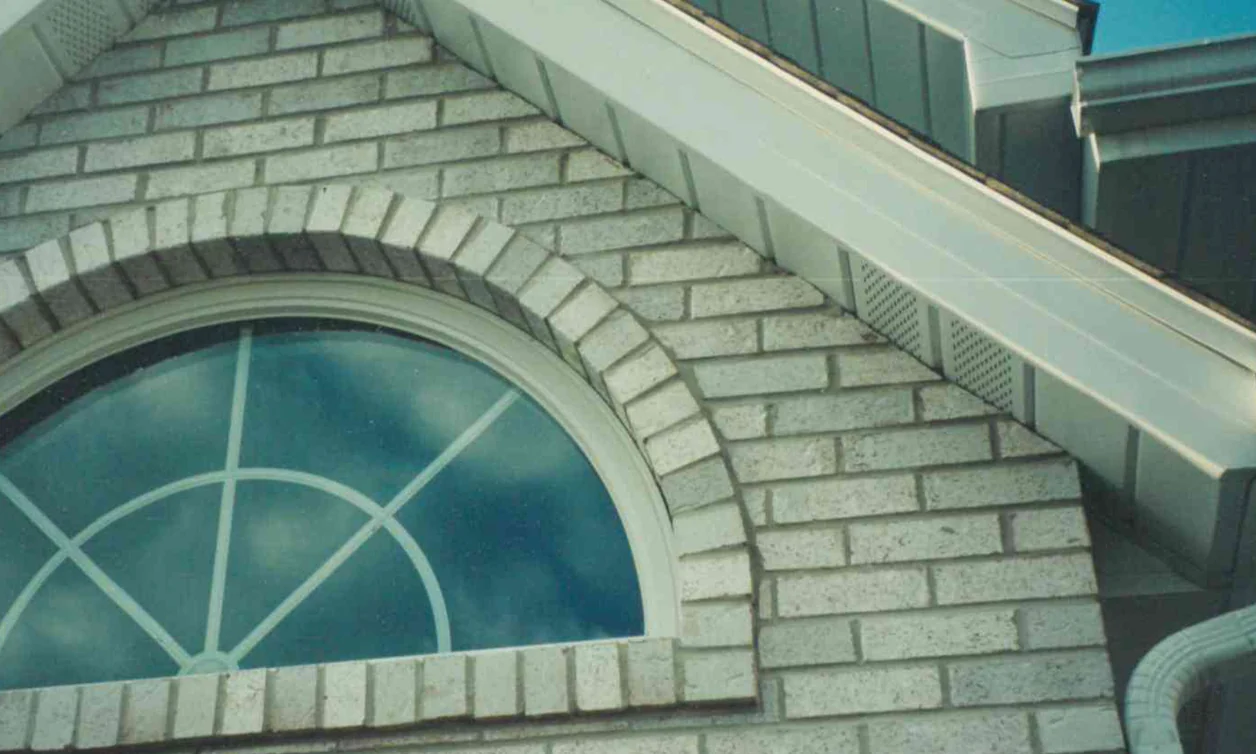 The gable of a house in Hobart, Indiana in 1999, its brick evened into one range around the arched window