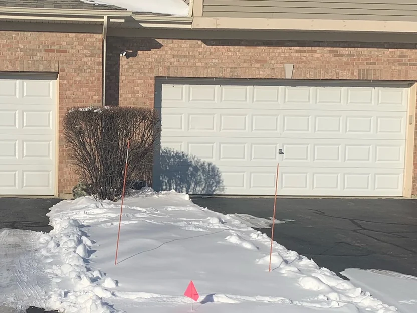 The same garage bay as the 2002 frames, photographed in 2019, the course over the door head reading in the same range as the wall on either side