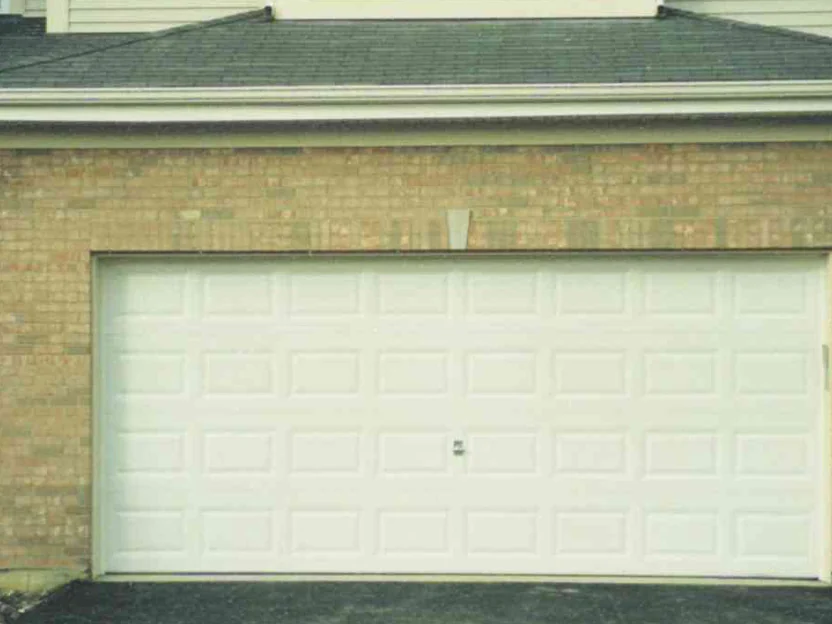 The same bay in 2002 with the work done to the door head, the course over the opening now reading in the same range as the wall, a pale cast stone wedge standing at the centre