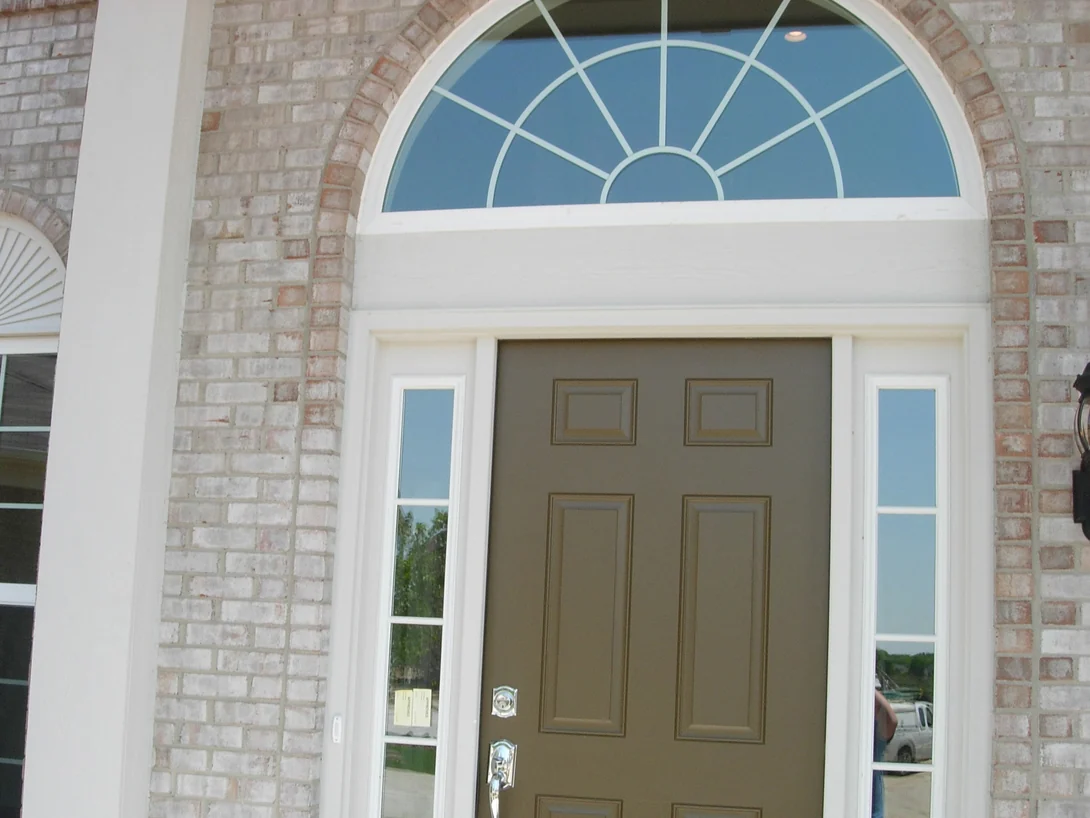 The front door under its arched fan window in 2007 with the work under way, the brick of the entry arch still chalky cream and pink