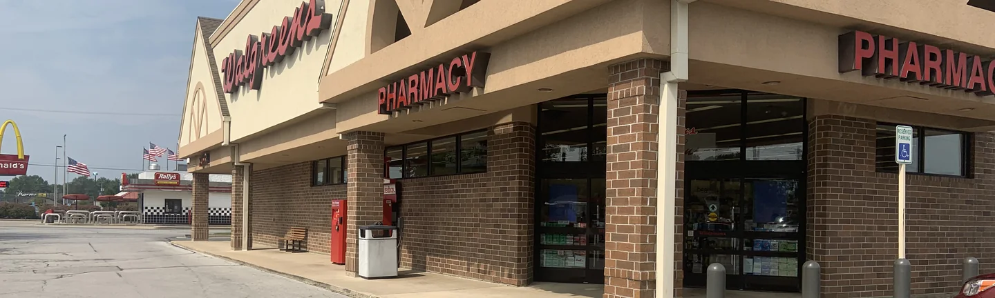 The Walgreens seen across its car park in 2019, the brick along the front reading as one even red brown range