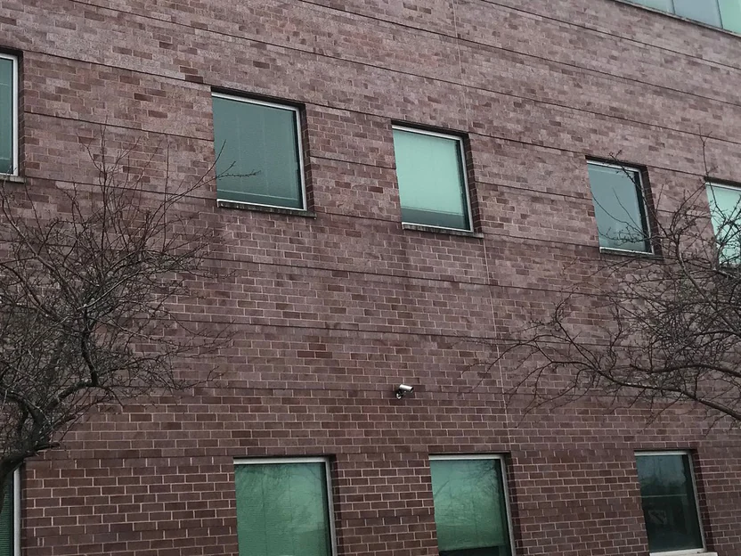 The large wall in 2021, the courses holding one even red range across the full width with rows of windows above and below