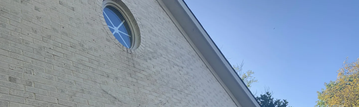 The gable end of the Indianapolis house in 2019, its brick reading as one cream and grey range