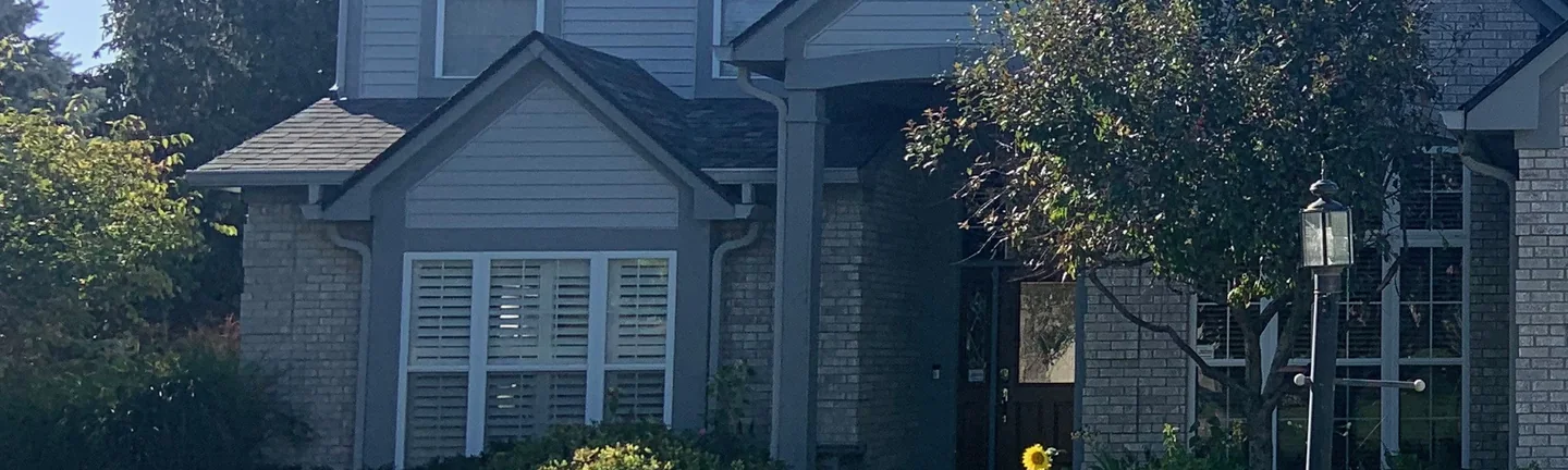 The front of the Indianapolis house in 2019, its brick reading as one even cream and grey range