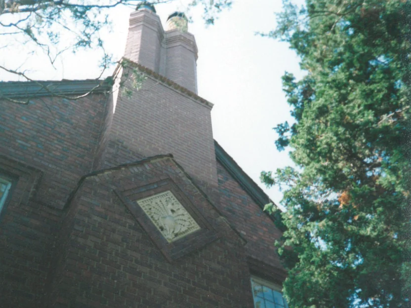 The gable and chimney of the house in 1998, the stack above the roof a pale grey against the darker brick below it