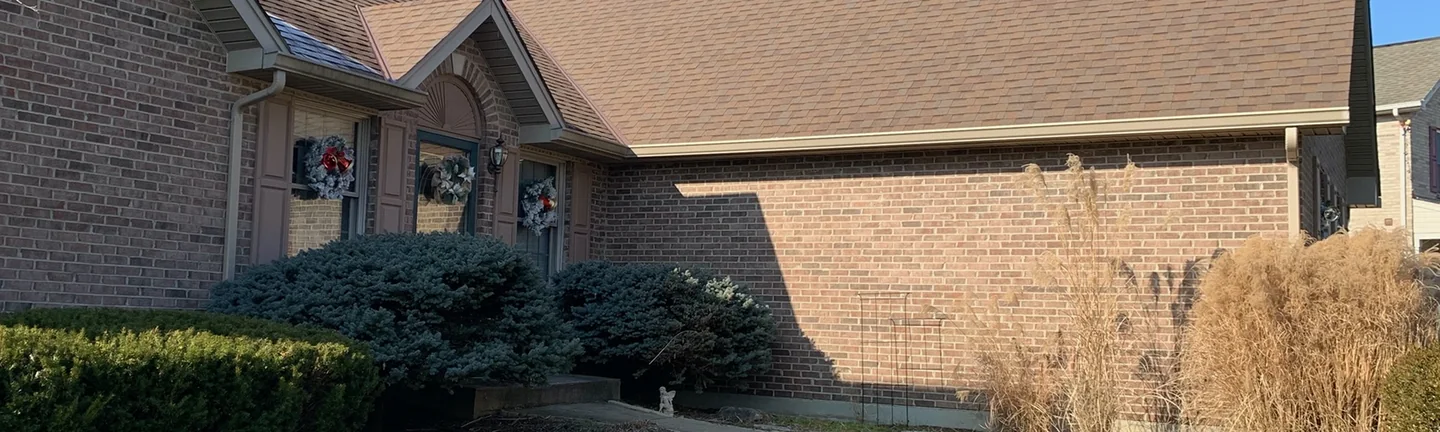 The front of the Kentucky ranch house in 2020, its brick reading as one red brown range across the entrance gable and the long wing beside it