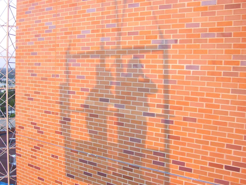 A high brick wall on the hospital in 2007 with the work finished, the blended range running unbroken across the face.