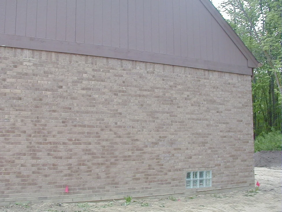 The same gable end later in 2005, the ladder gone and the brick carrying one buff and tan range from the corner to the far edge of the frame