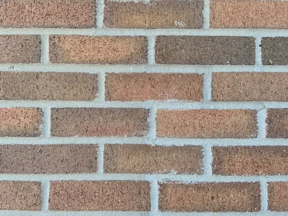 Close view of school brick running a range of pink, buff and grey units across pale mortar joints