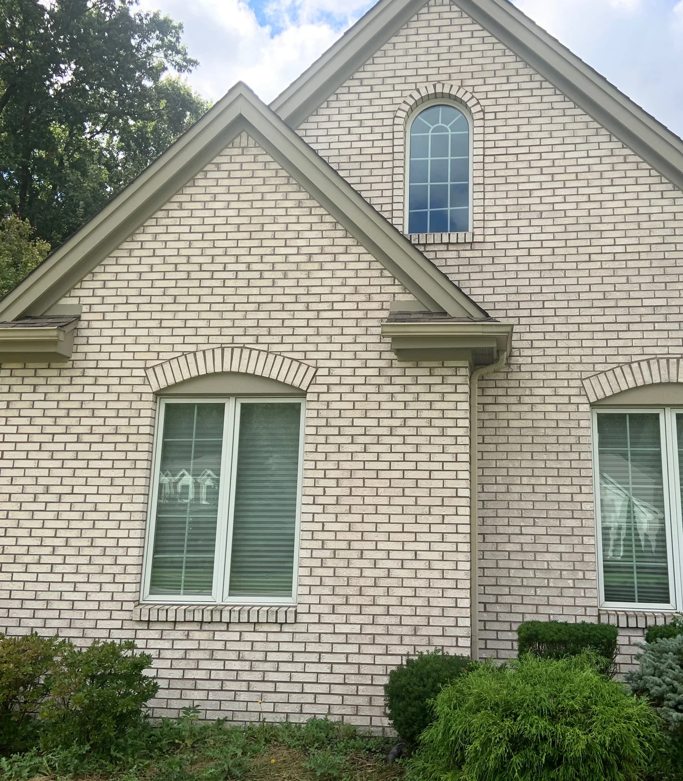 Two gables on a house in Lost Creek, Ohio in 2019, the pale brick one even color twenty-one years after it was lightened