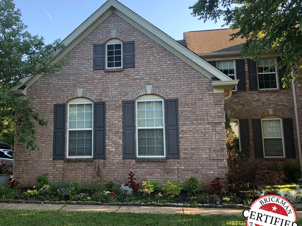 The front gable of the Louisville house in 2019, its brick an even blend of tan, pink and brown.